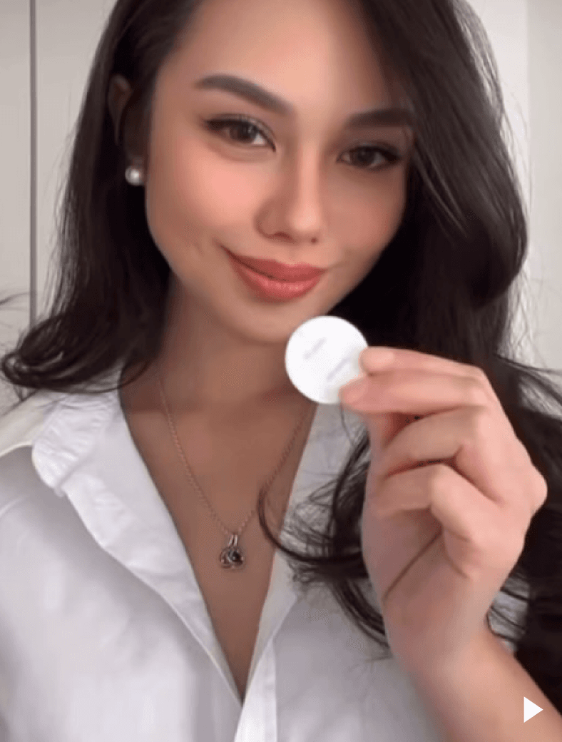 Smiling person holding patch